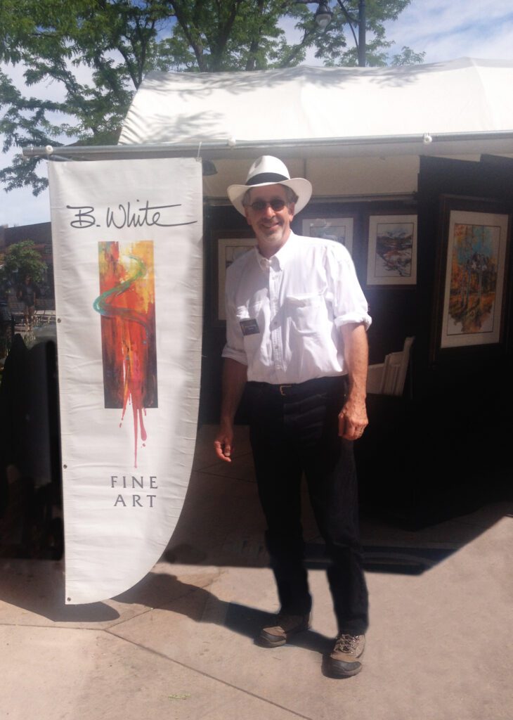 Bruce White artist at booth in Grand Junction
