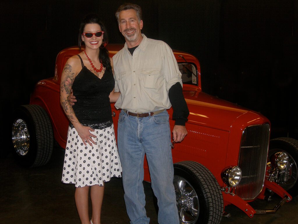 Bruce White at car show with pinup winner